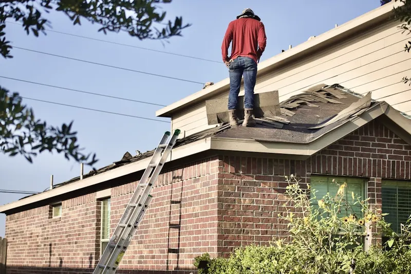 Professional roofer working on a residential roof in Round Lake Beach